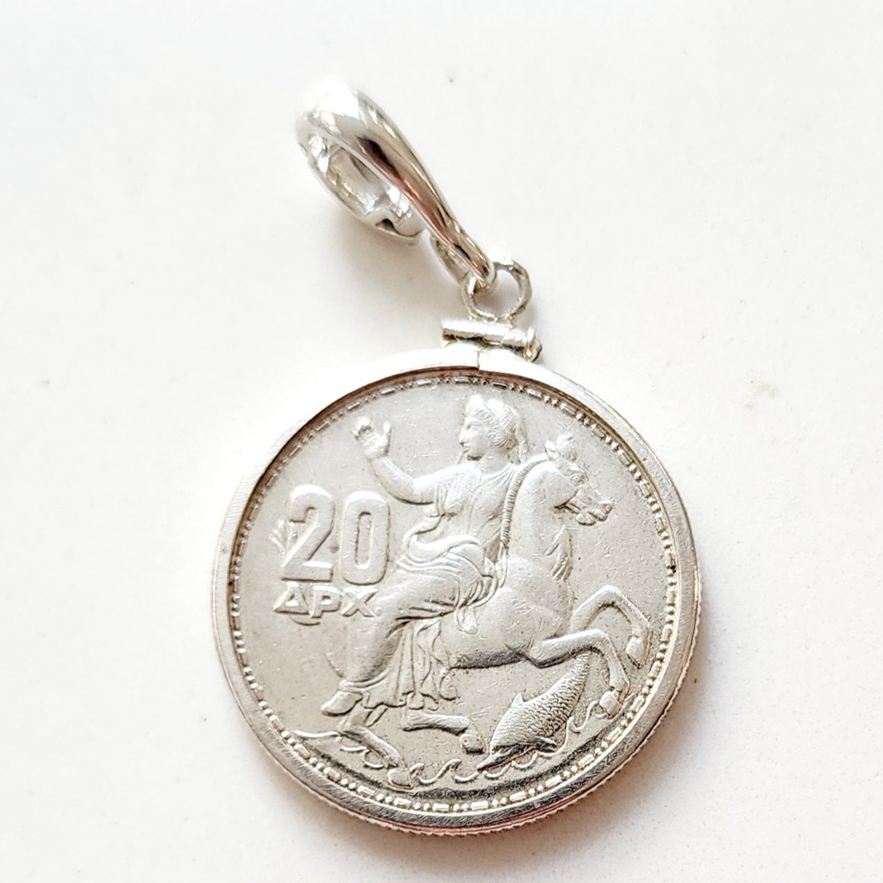 1960 Greek 20 drachma silver coin of the Moon Goddess Selene riding a horse with a dolphin below. Set in a sterling silver coin mount.