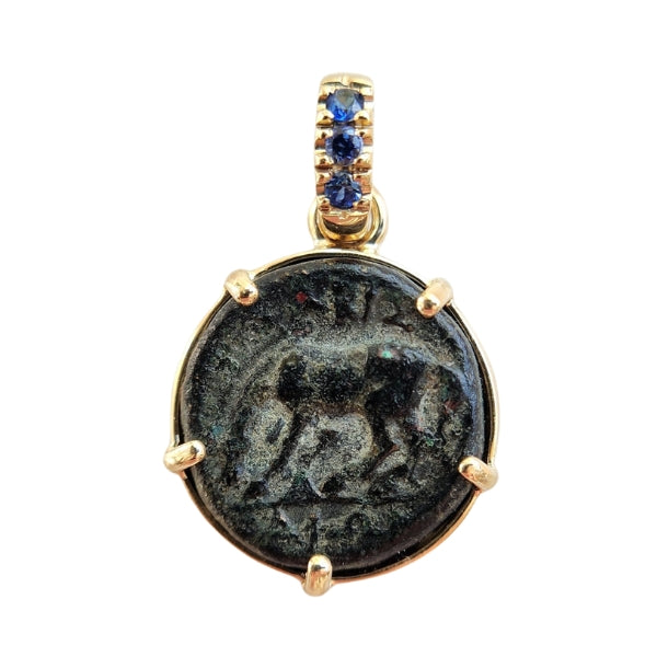 Ancient Greek bronze coin from Thessaly with a horse getting ready to roll. Set in 18kt gold with sapphires in the bail.