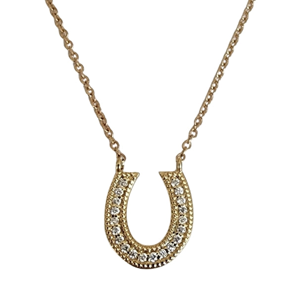 Horseshoe necklace accented with diamonds and milgrain detail. 14kt gold.