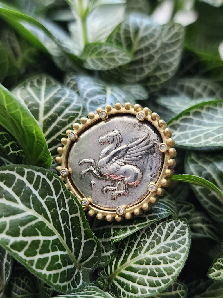 Ancient Corinthian Stater with Pegasus.  18kt gold ring with diamond accents in the prongs.