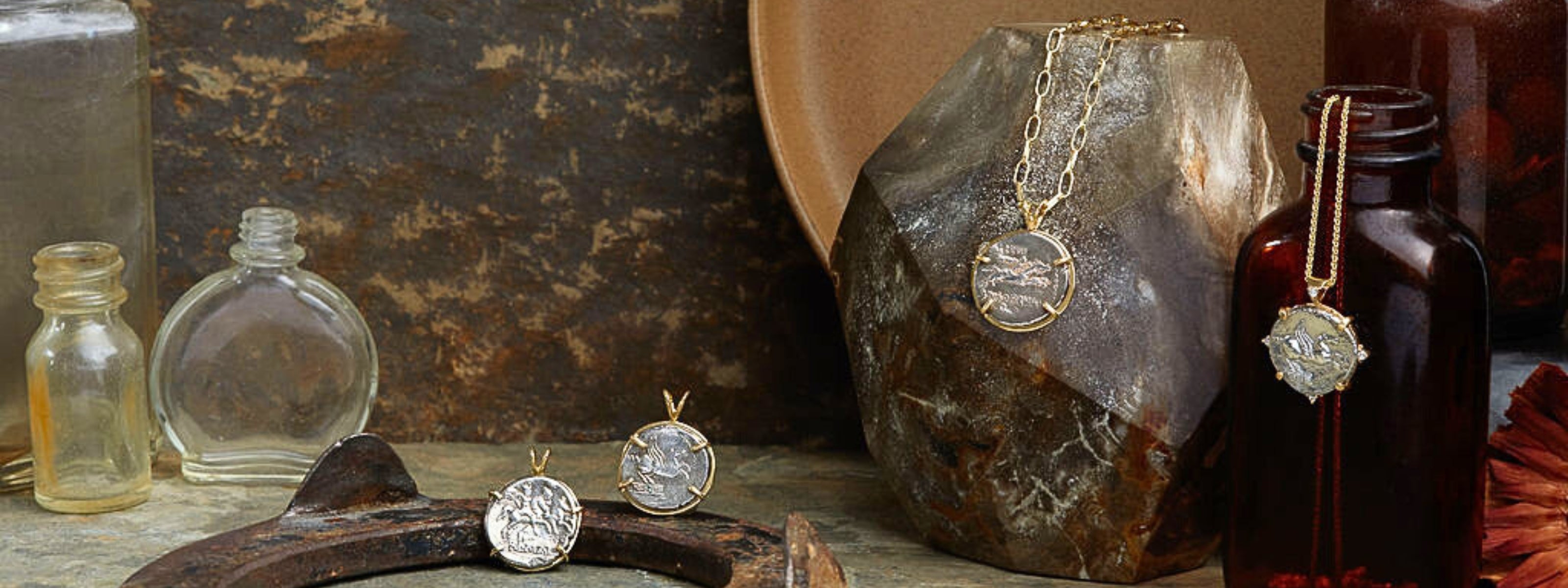 Ancient Roman coins set in 18kt gold on rustic background