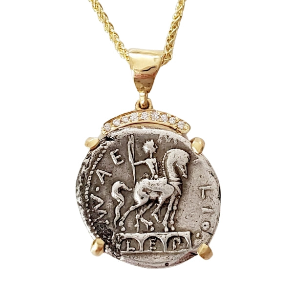 Ancient silver coin from the Roman Republic 114 BC  Horse and rider statue on top of a triple arch.  18kt gold setting with a crown of pave diamonds.  Roma on the back.