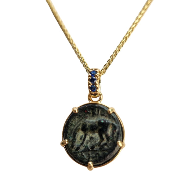 Ancient Greek Bronze coin of a horse getting ready to roll from Larissa, Thessaly in an 18kt gold setting with sapphire enhanced bail.