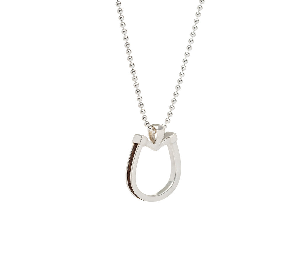 Silver horseshoe pendant with inset horsehair braid